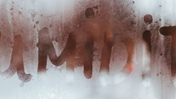 Humidity is written on a pane of glass.