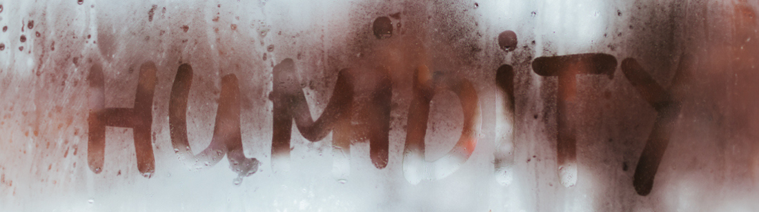 Humidity is written on a pane of glass. 