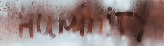 Humidity is written on a pane of glass. 